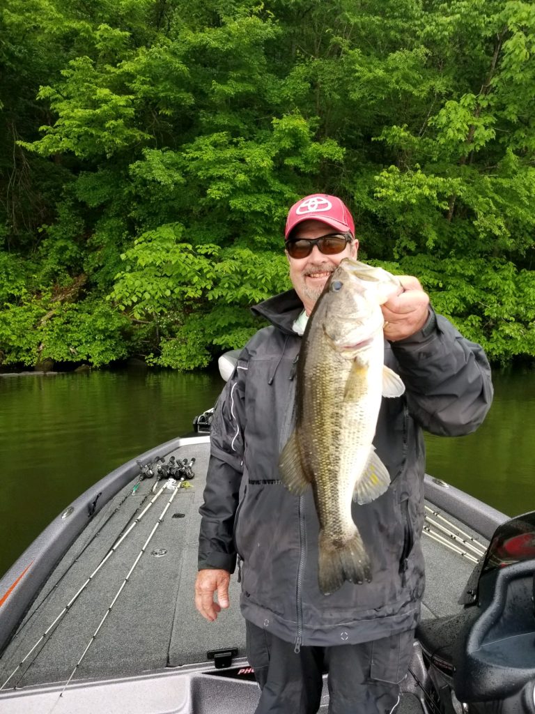 Fishing in Tuscaloosa County: Dalton Bobo catches a bass fish in the Holt Lake section of the Black Warrior River