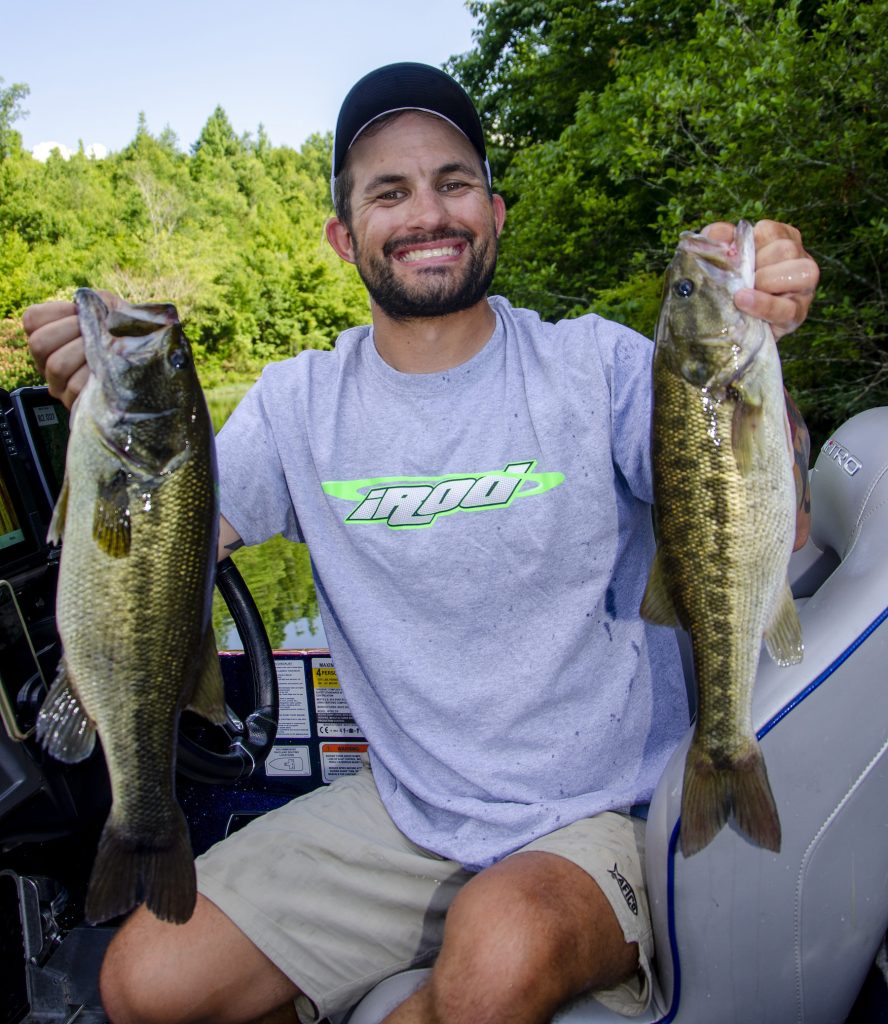 Largemouth Bass with brush hog lure hanging out of its mouth Stock