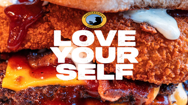 A mouthwatering burger with crispy chicken, bacon, cheese, and sauces in Tuscaloosa, Alabama.