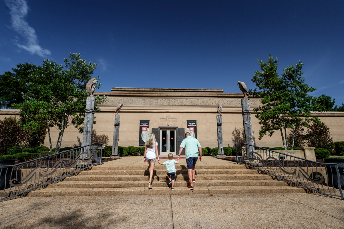 A family walking with their child up the steps to the Lost Ream of the Black Warrior