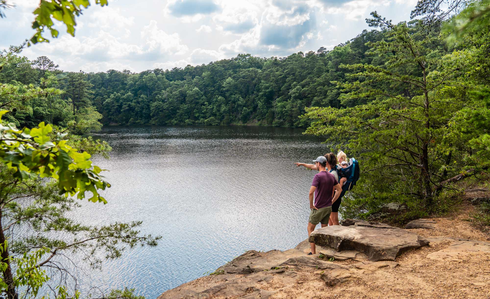 two people standing and looking over a large lake