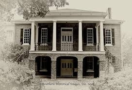 A grand, historic mansion called the Gorgas House with a distinctive architectural style, featuring columns and a balcony in Tuscaloosa, Alabama.
