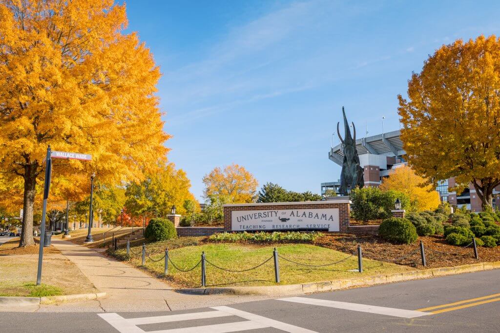 Autumn scene at the University of Alabama, featuring vibrant trees and Tuska