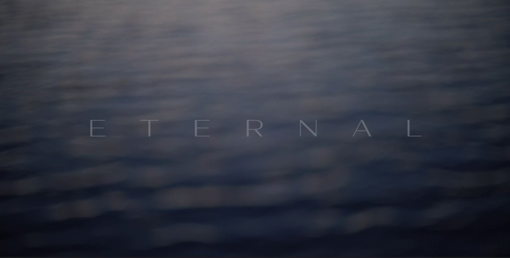 A serene, blurred image of rippling water with the word 'ETERNAL' inscribed in light gray letters across the center