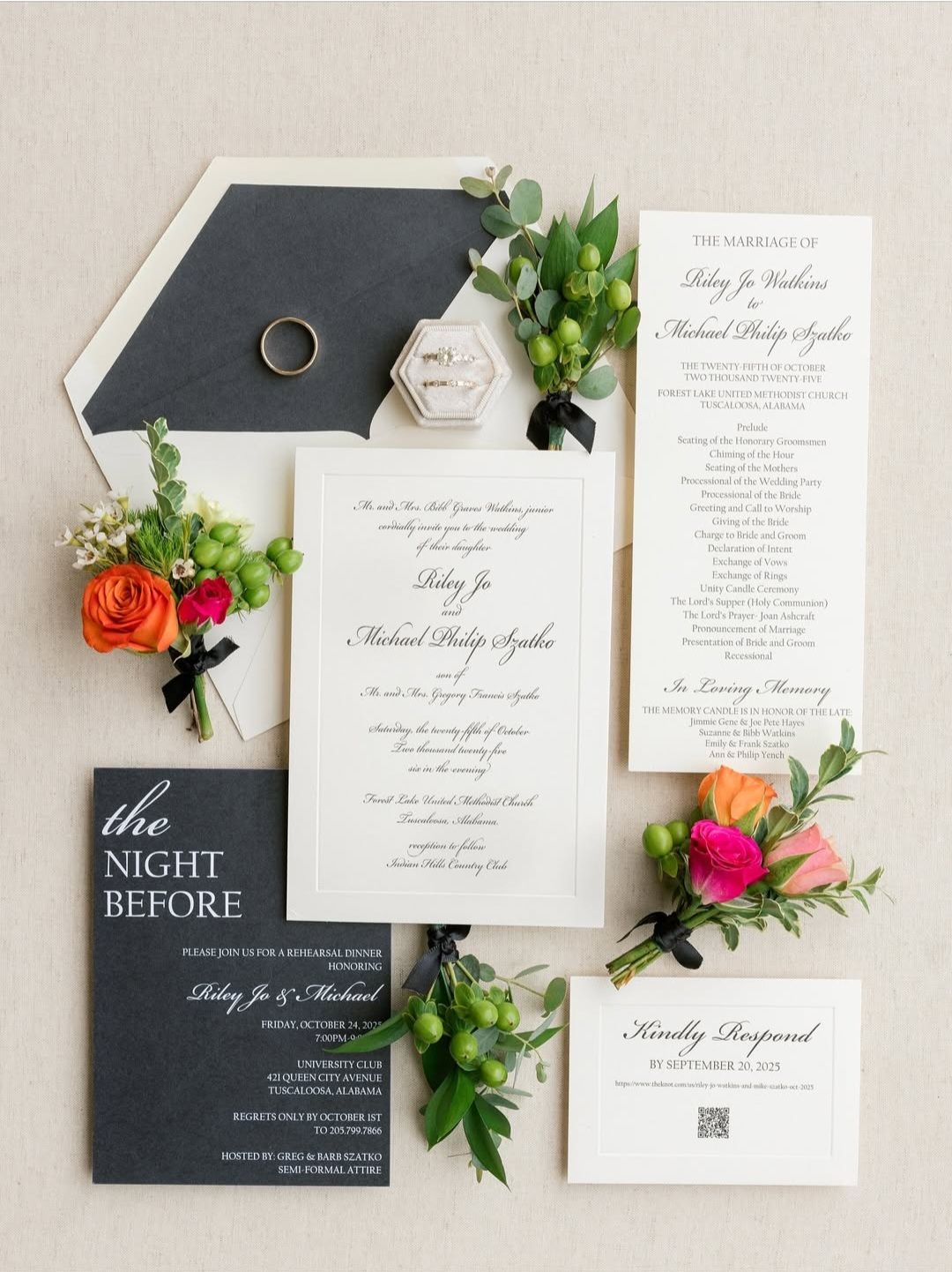 An elegant wedding invitation suite featuring a black and white color scheme with floral accents and a gold ring