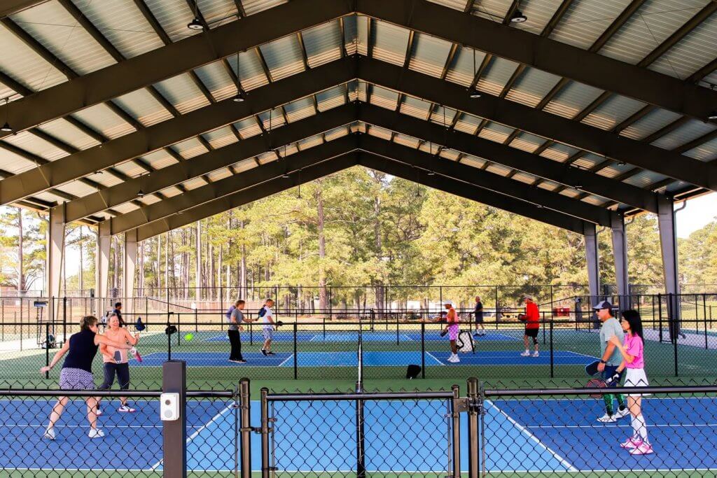 People playing pickleball on newly covered courts at Bowers Park in Tuscaloosa, Alabama.