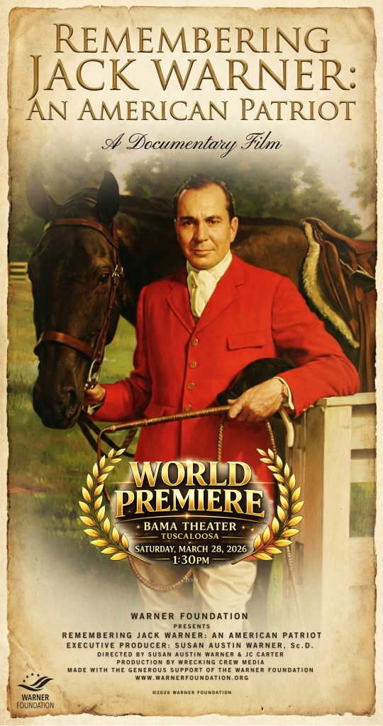 A man in a red suit stands next to a horse, holding its reins