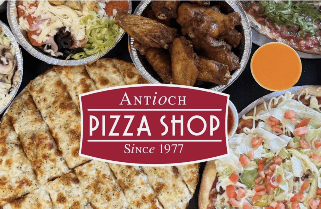 A variety of Italian dishes including pizza, chicken wings, and garlic bread, served at a restaurant named Antioch Pizza Shop