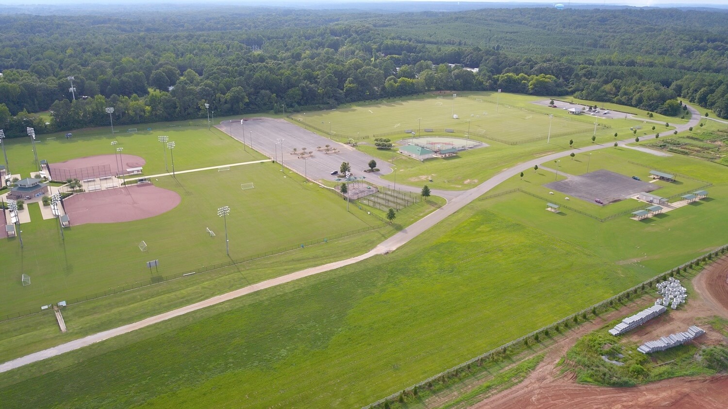 A sports complex with multiple fields and facilities, surrounded by lush greenery in Sokol Park North located in Northport, Alabama.