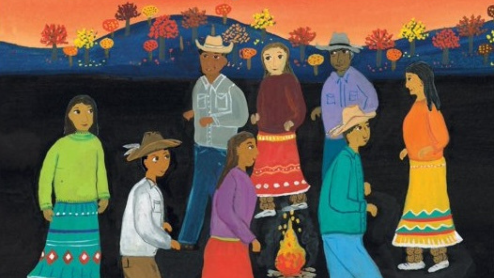 A diverse group of people dressed in colorful traditional attire gather around a campfire under a vibrant autumn sky in Tuscaloosa, Alabama.