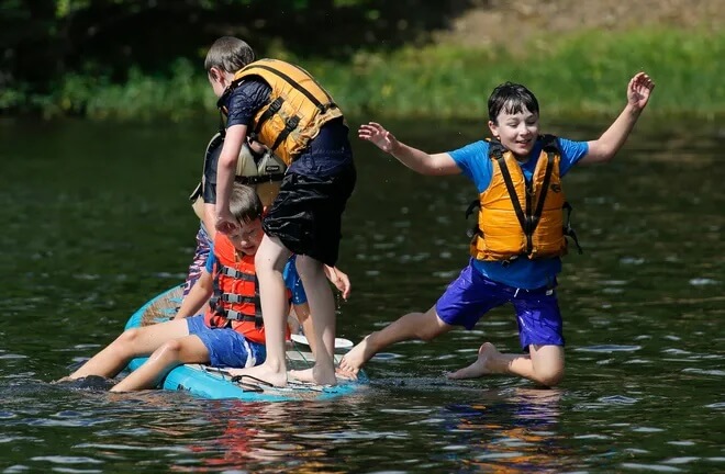 children enjoying paddle boarding at Lake Nicol in tuscaloosa, alabama
