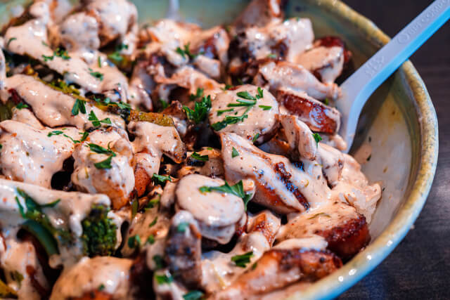 A bowl filled with creamy chicken and broccoli casserole topped with melted cheese and herbs in Tuscaloosa, Alabama.