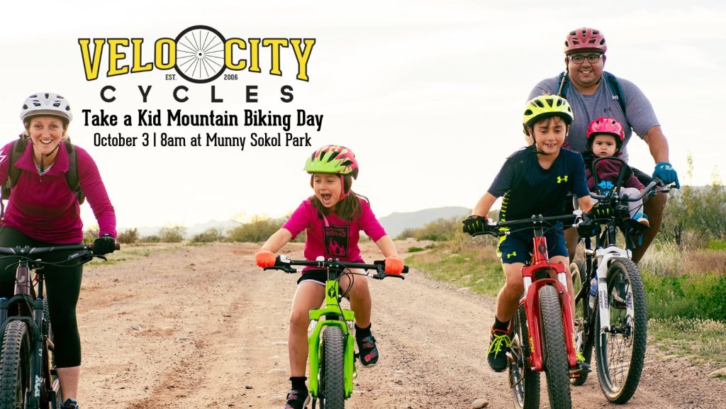 A family riding mountain bikes on a dirt trail for a cycling event in Tuscaloosa, Alabama.