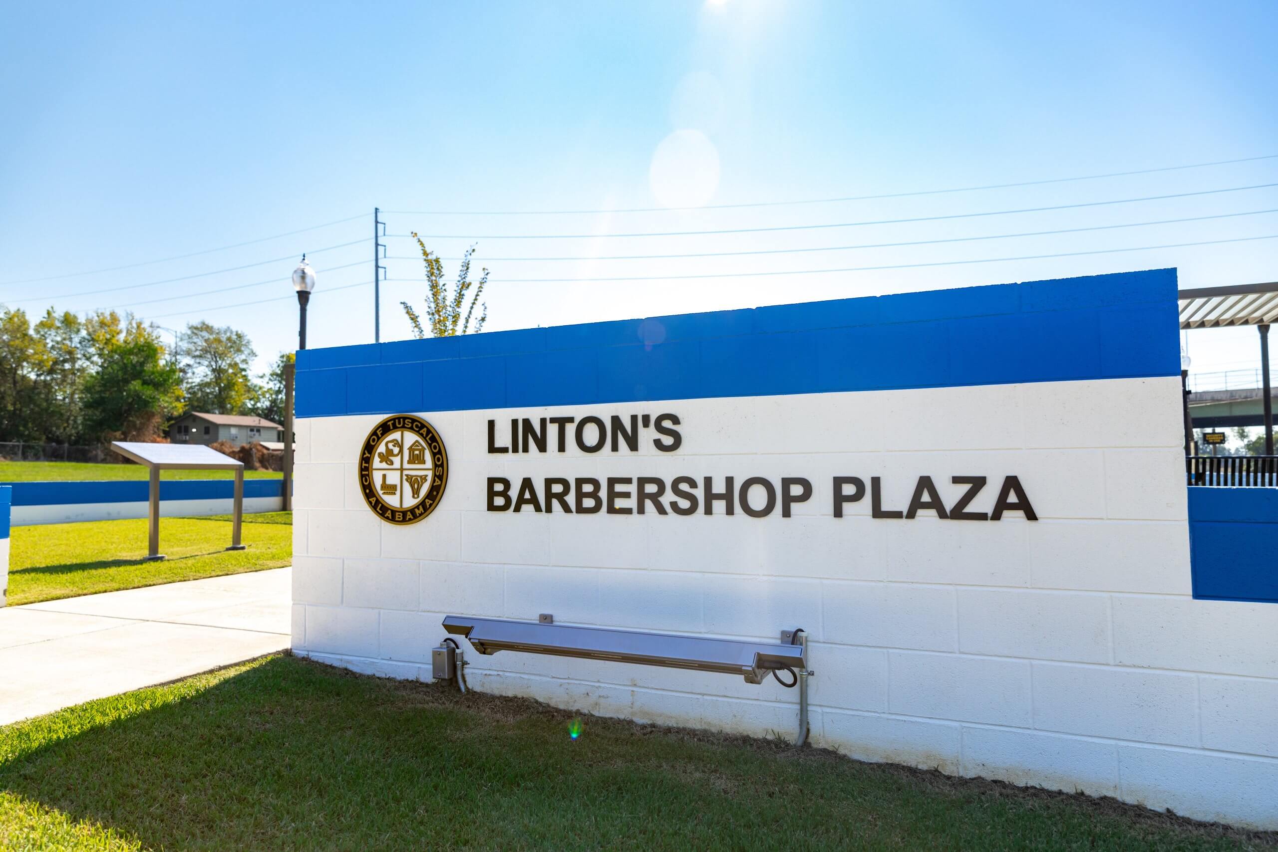 A white and blue sign for Linton's Barbershop Plaza in Tuscaloosa, Alabama in Tuscaloosa, Alabama.